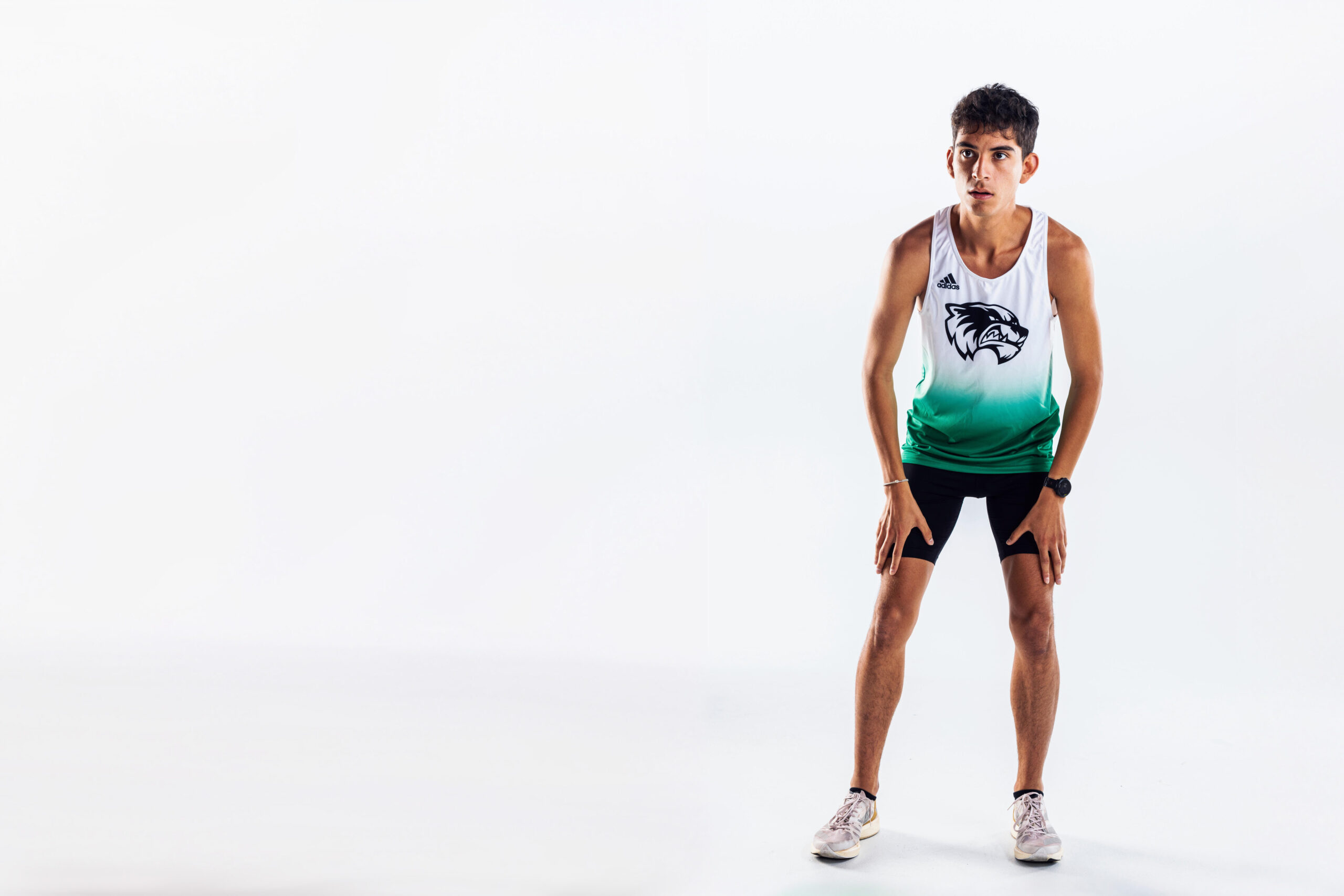 Gio Posing in white background in track singlet